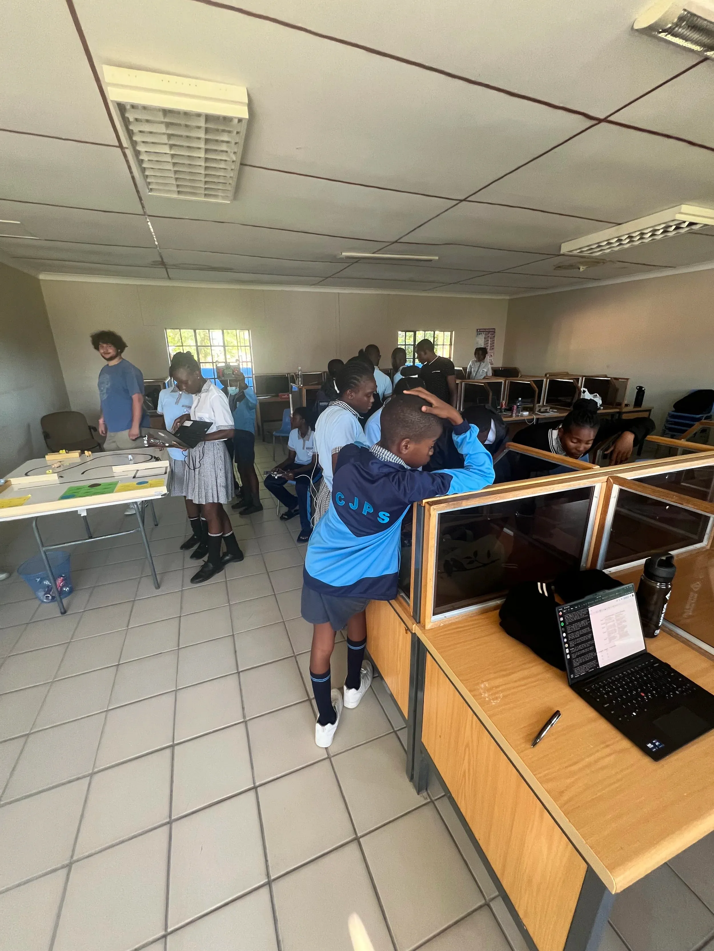Students at laptops in a school computer lab during the robotics bootcamp